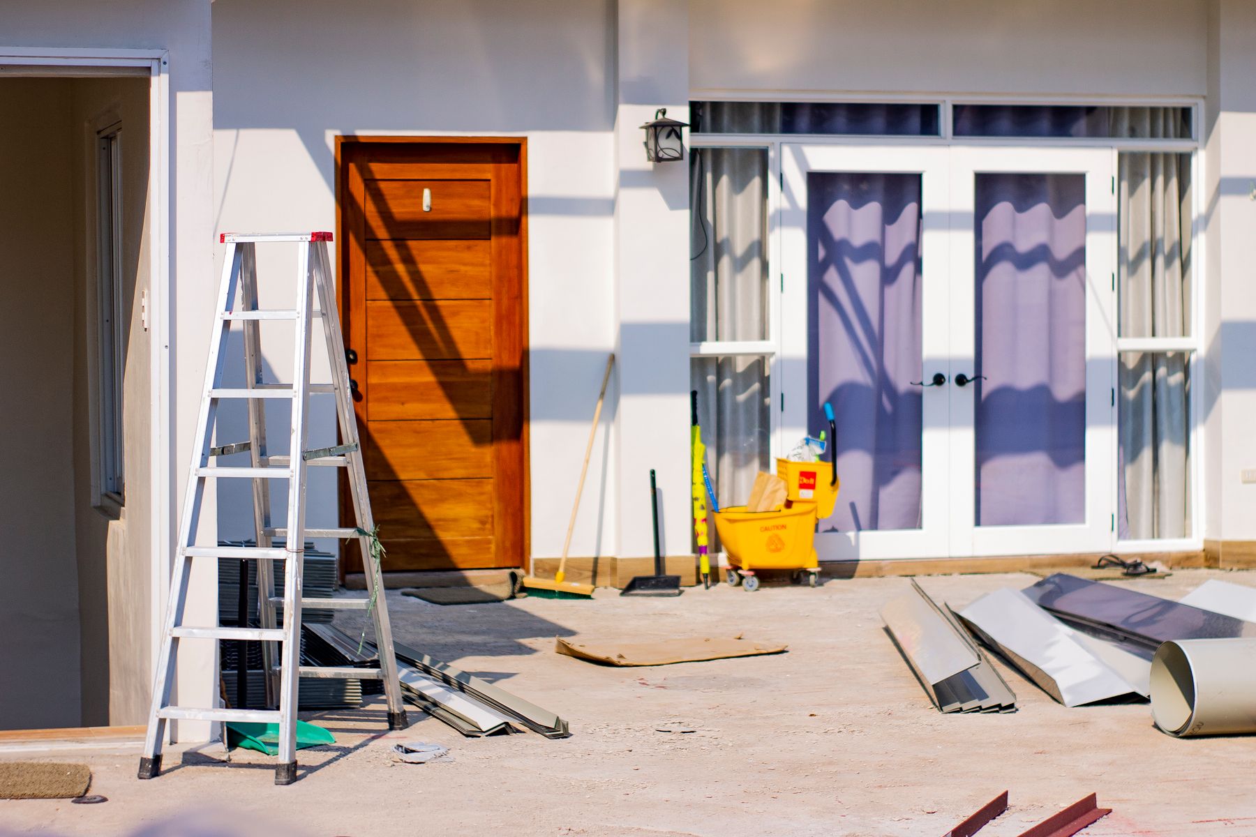 Sample house entrance under renovation with tools and materials