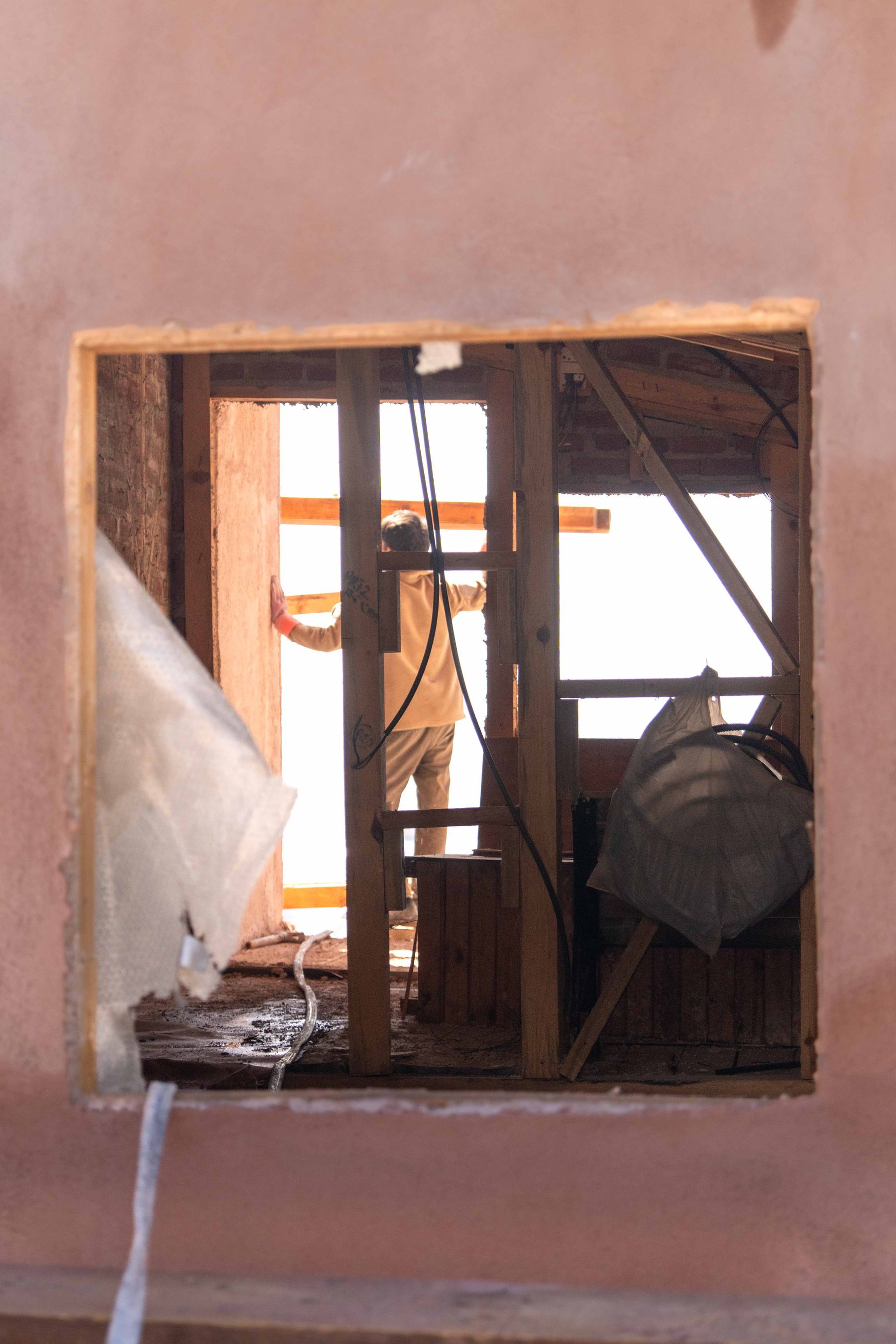 Sample interior renovation with worker and exposed framing